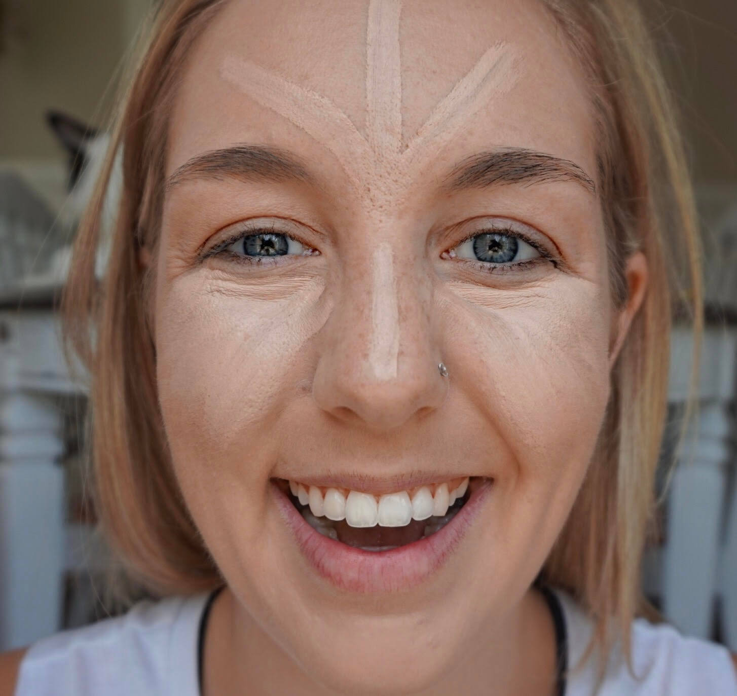 applying concealer to face