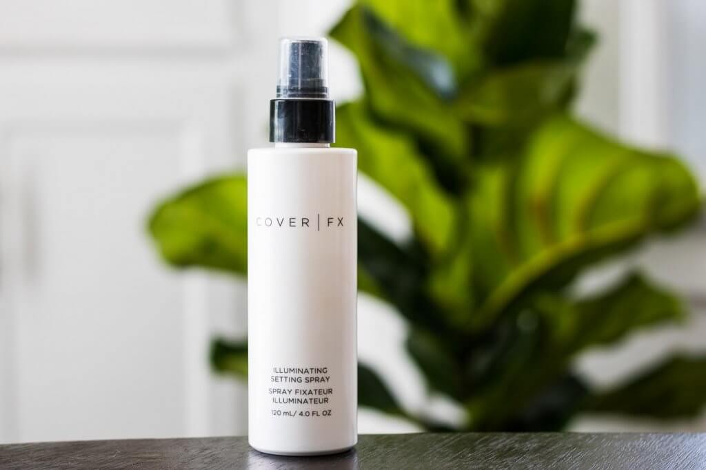 cover fx illuminating setting spray in front of green plant